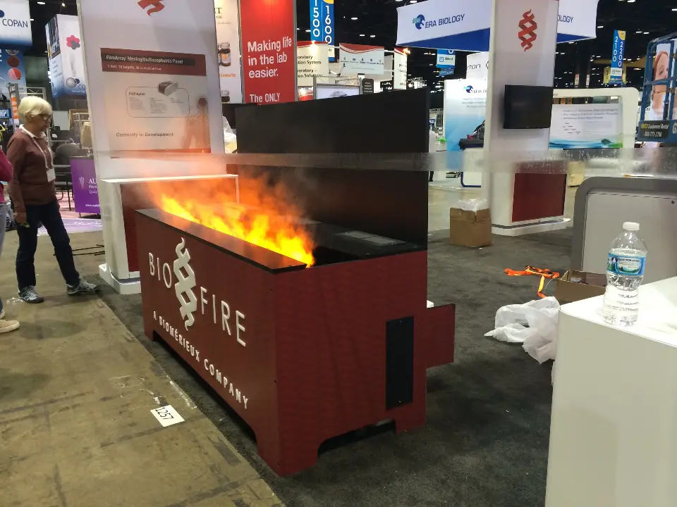 Long dark red BioFire counter with a flame effect on top beside the aisle