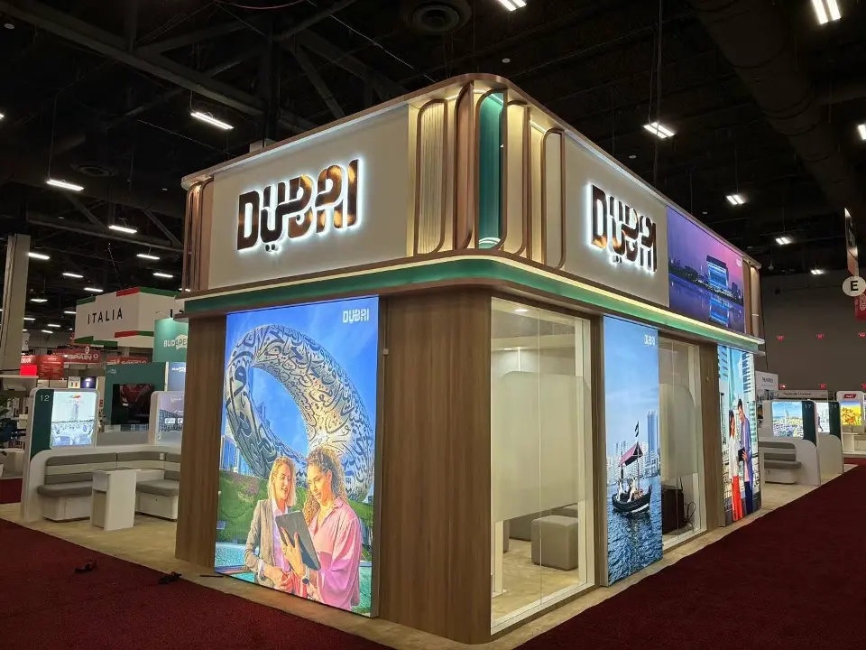 Tall backlit Dubai graphics and wood-look frame at the pavilion corner
