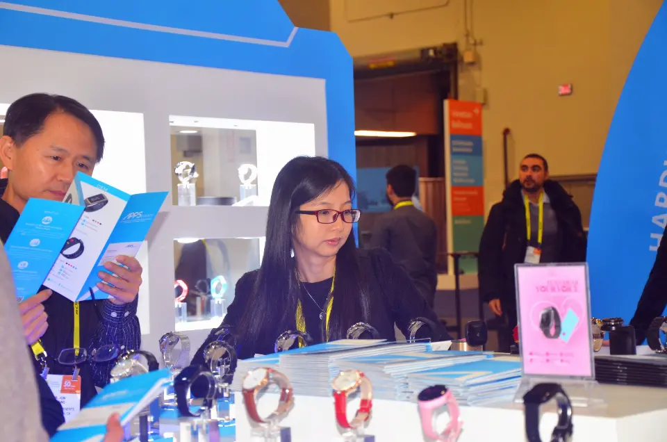 Staff showing watch products to visitors at the display counter