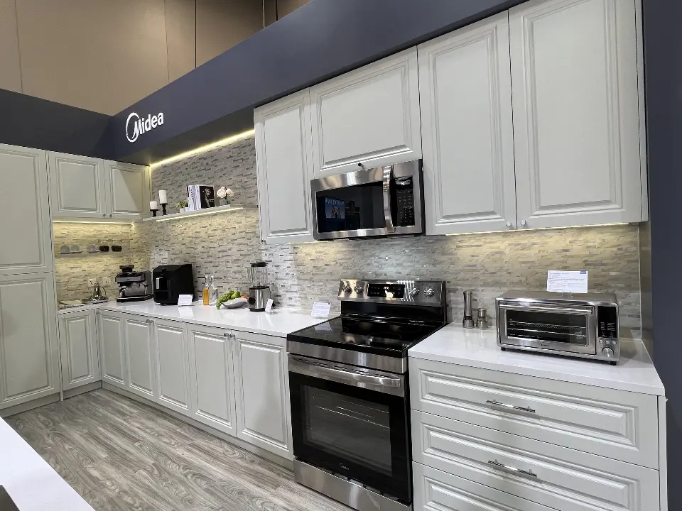 Kitchen vignette with a range, microwave and glass-front cabinets