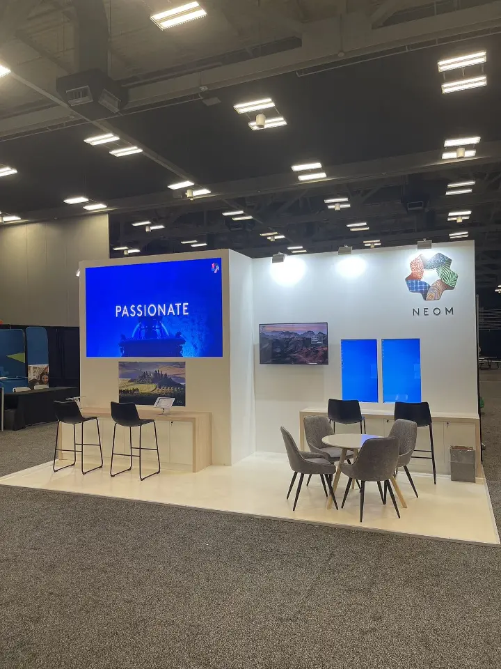 Video screen showing the word Passionate beside a round meeting table