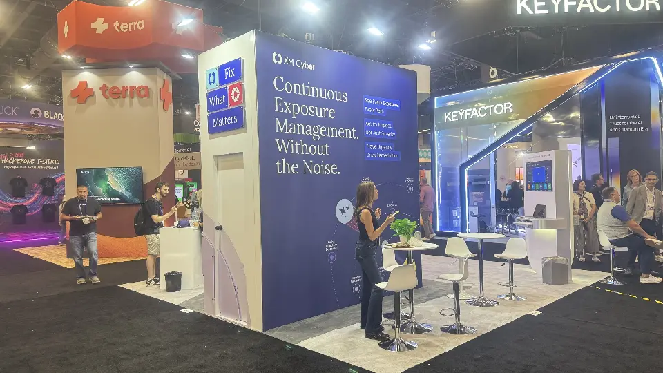 Navy Continuous Exposure Management wall with white type beside a visitor