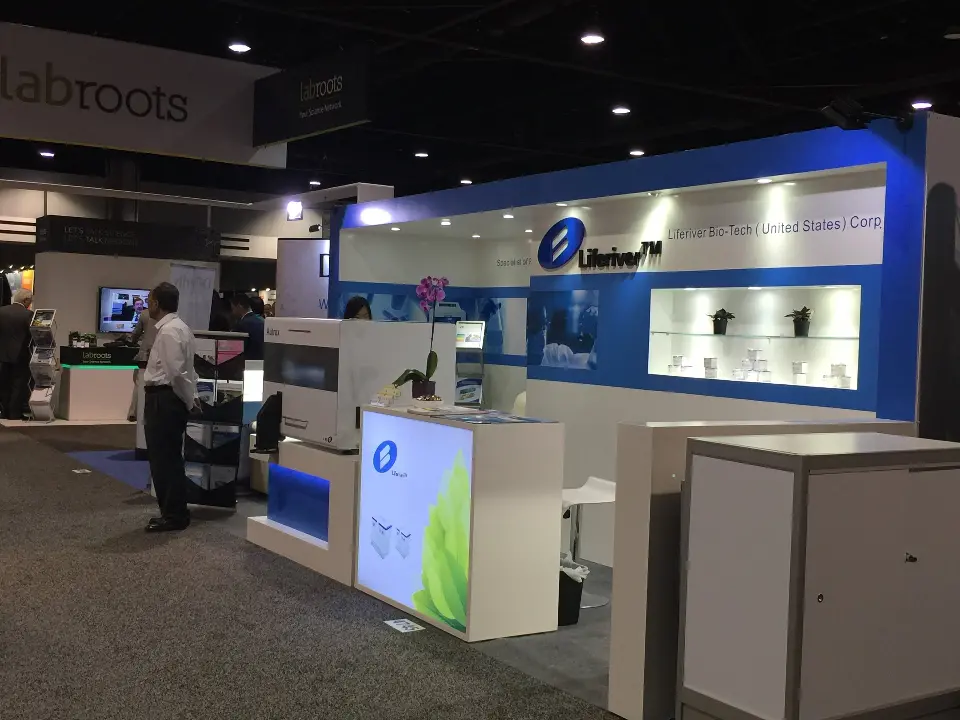 Side view of the Liferiver booth with blue counter panel and white lightbox
