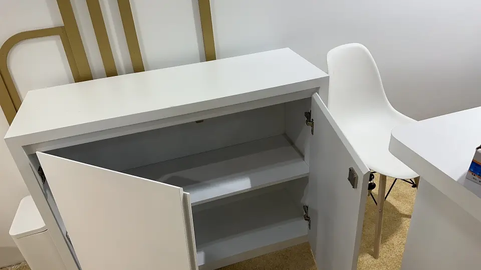 White storage cabinet with its door open showing inner shelves