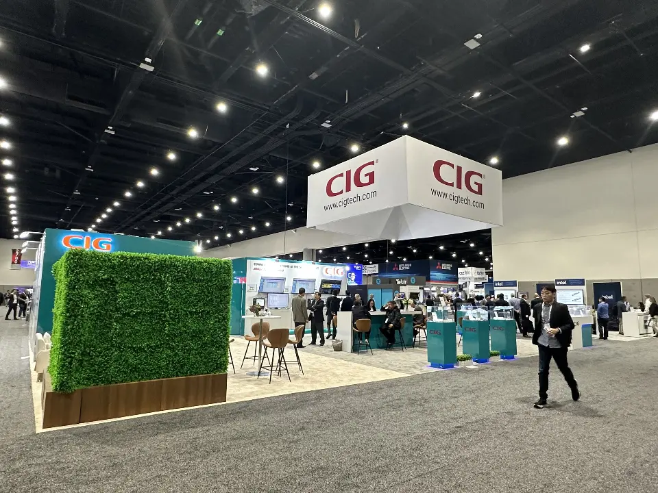 Wide view with green plant wall corner and white square CIG hanging sign