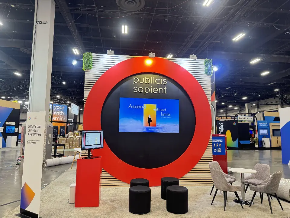 Slightly closer front view of the red ring with screen, kiosk and round ottomans