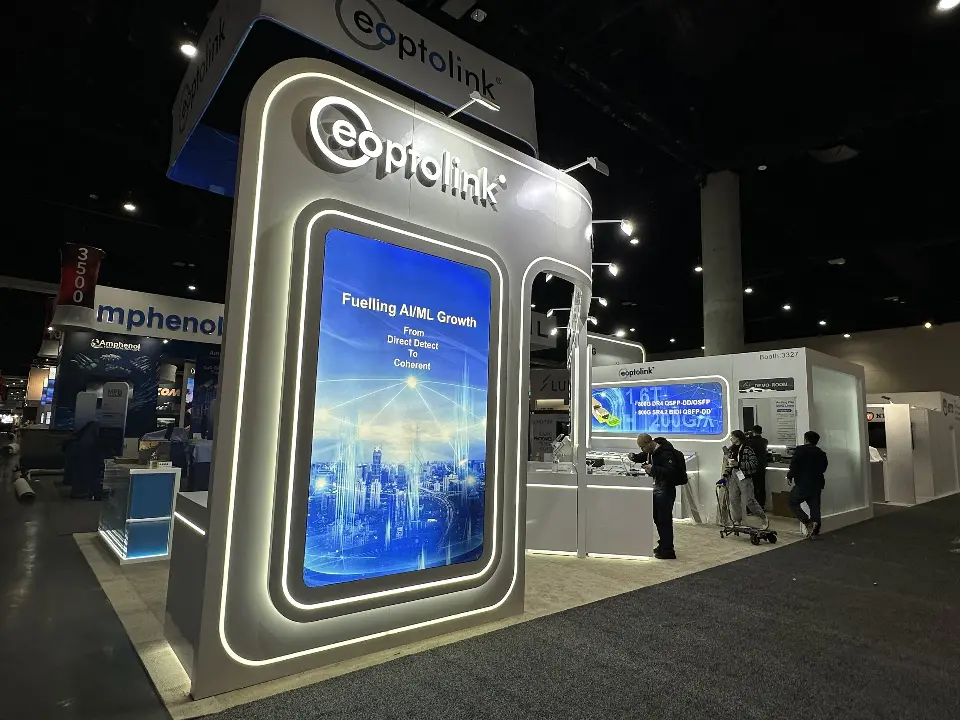 Front corner of the Eoptolink booth with a tall lit frame and hanging header