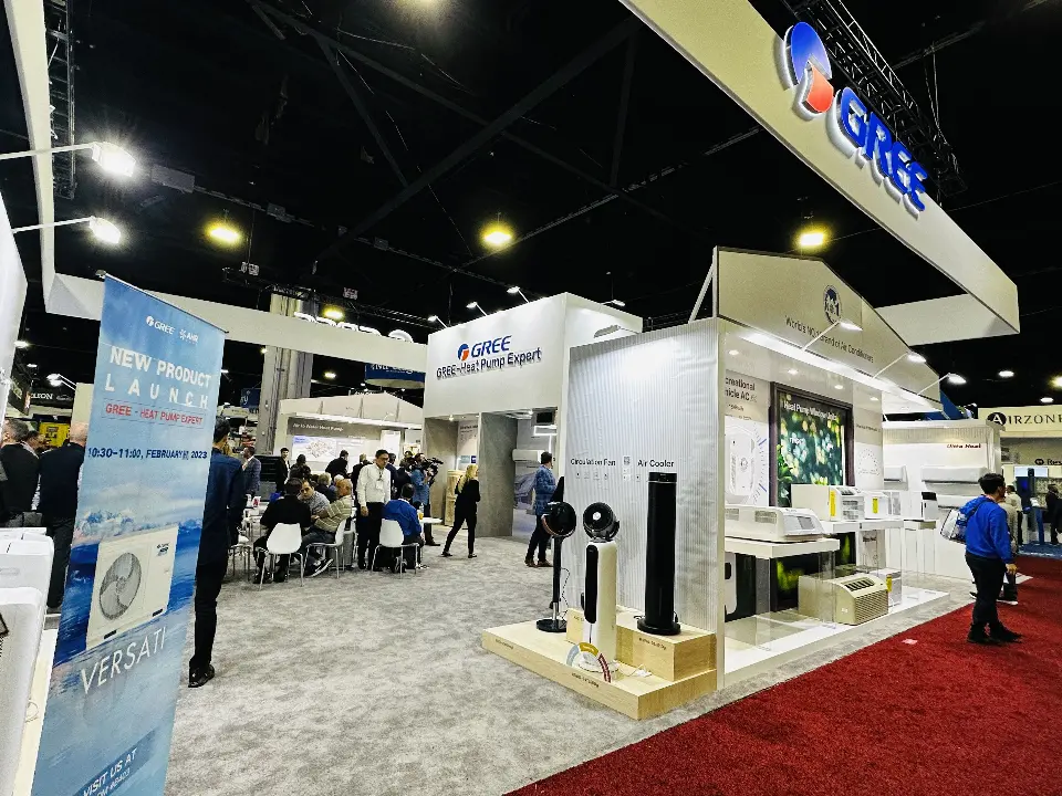 Inside the GREE stand: circulation fan and air cooler display, window units and a busy seating area