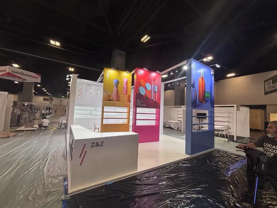 Corner view of the white counter beside yellow, magenta and blue shelf towers