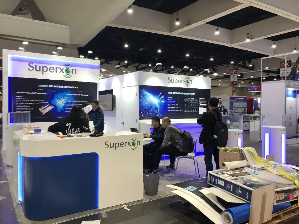 During build-up: white Superxon counter and blue graphic wall with crew at work