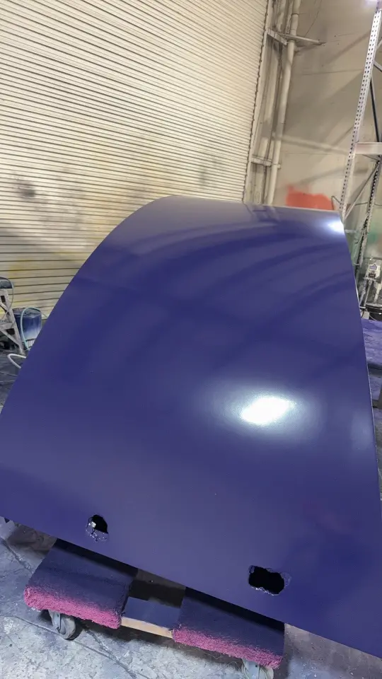 During build-up: curved navy panel section wrapped in the workshop
