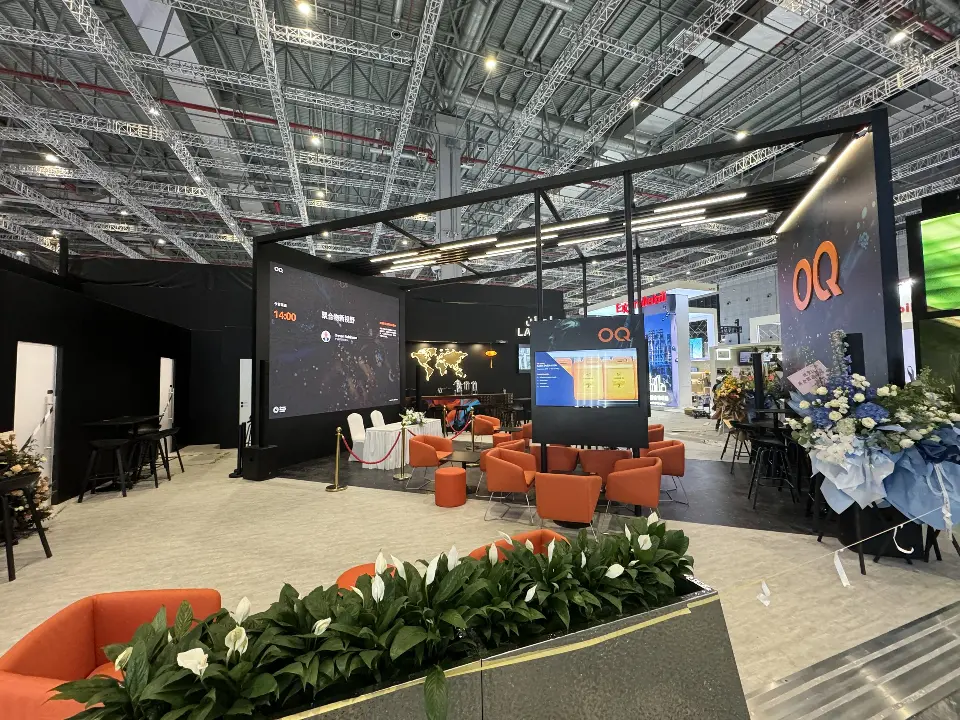 Side view across planters toward the lounge, video screen and OQ tower