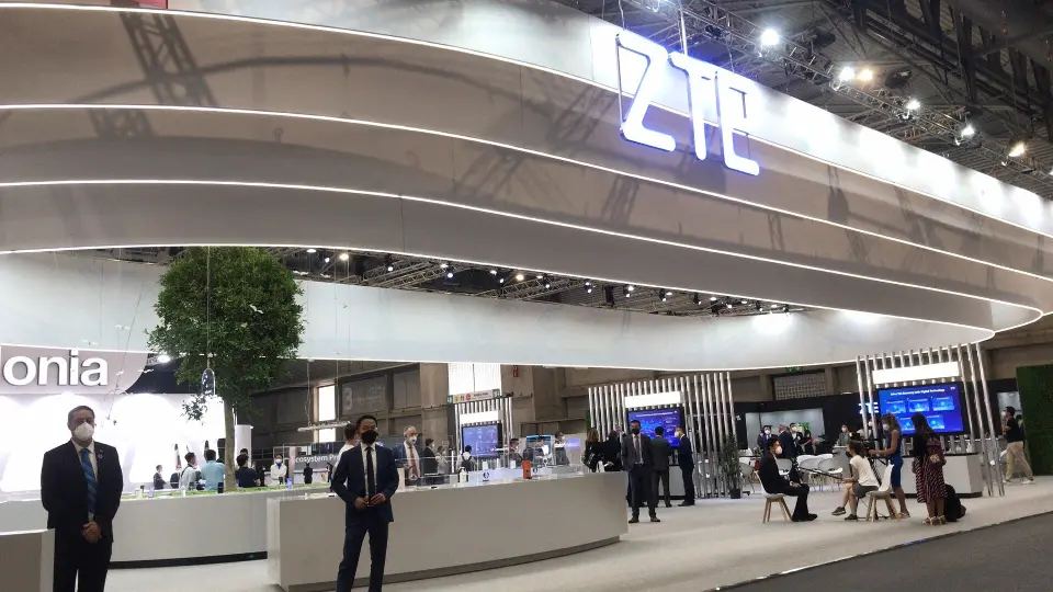 Upper canopy logo and white counters with guests in the late hall