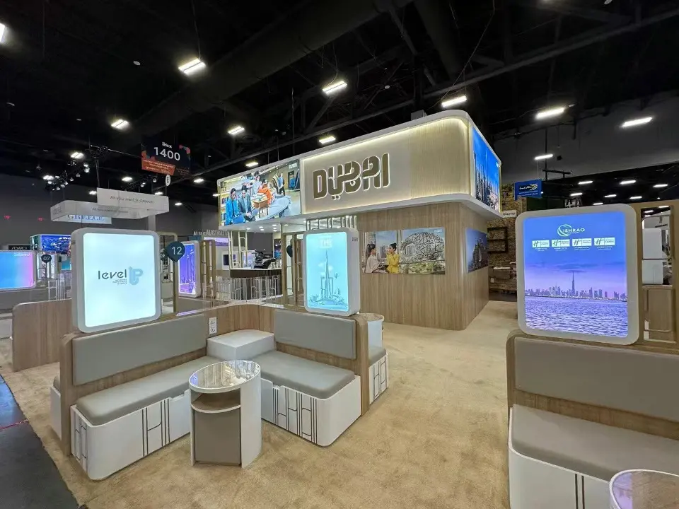 Interior aisle of the pavilion with counters and tall lightbox panels