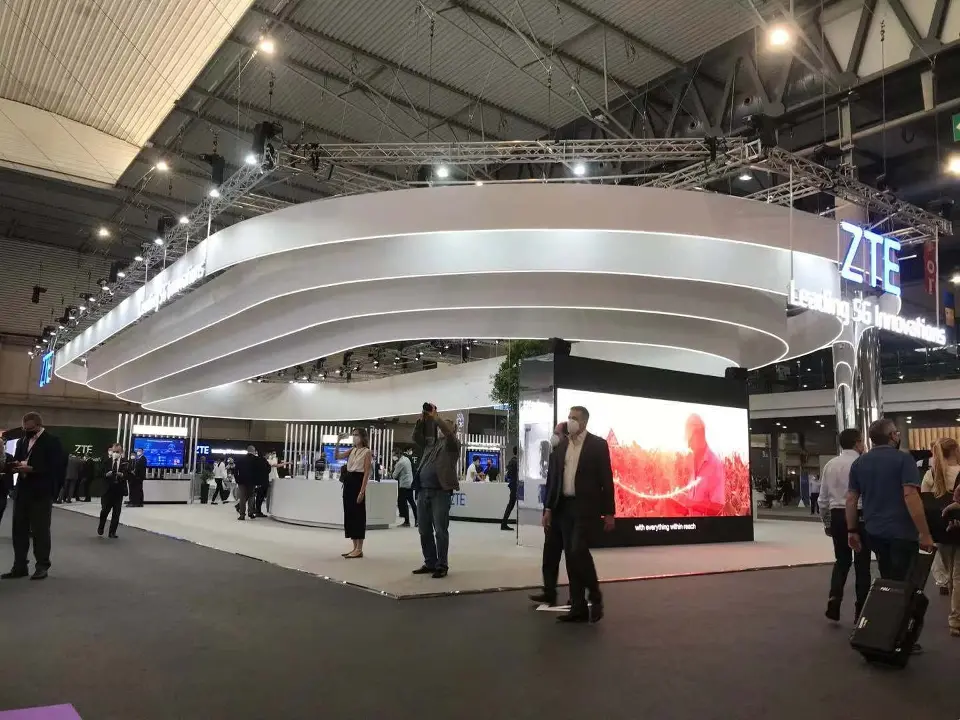 Hall view of the canopy with visitors and a video screen in the background