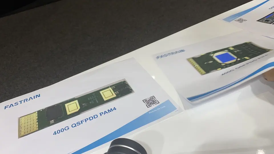 Close-up of FASTRAIN 400G module product cards on a table