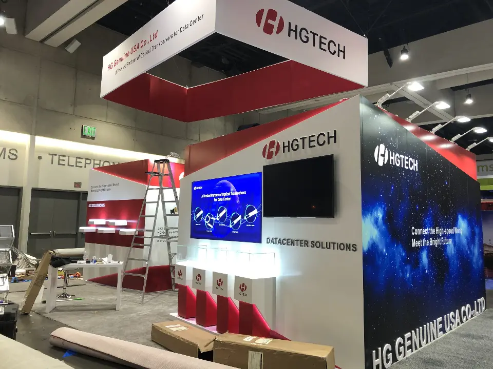 During build-up: dark blue graphic wall, wall screen and red seating at HGTECH