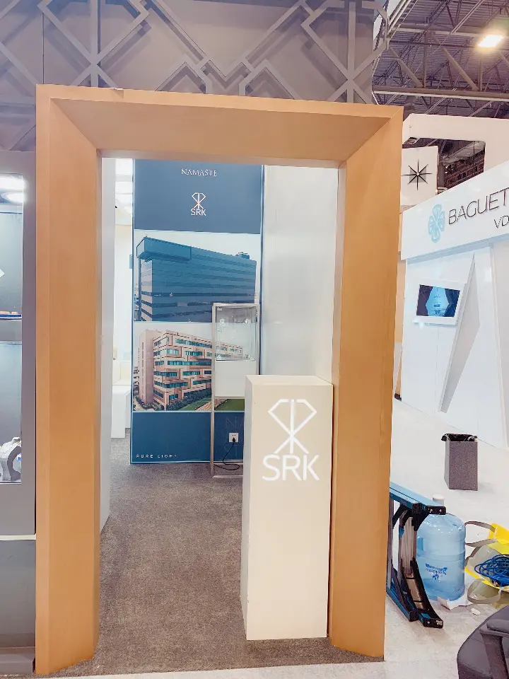 Close vertical view through the wood-trimmed doorway into the booth interior