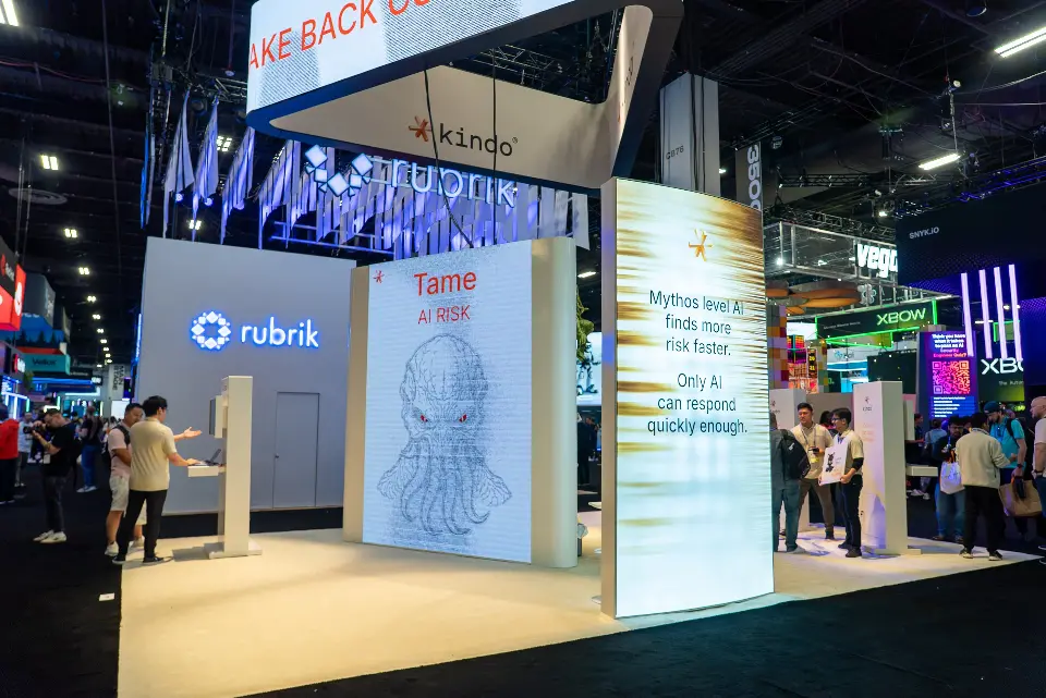 Side view of the lit white towers with printed messaging and visitors nearby