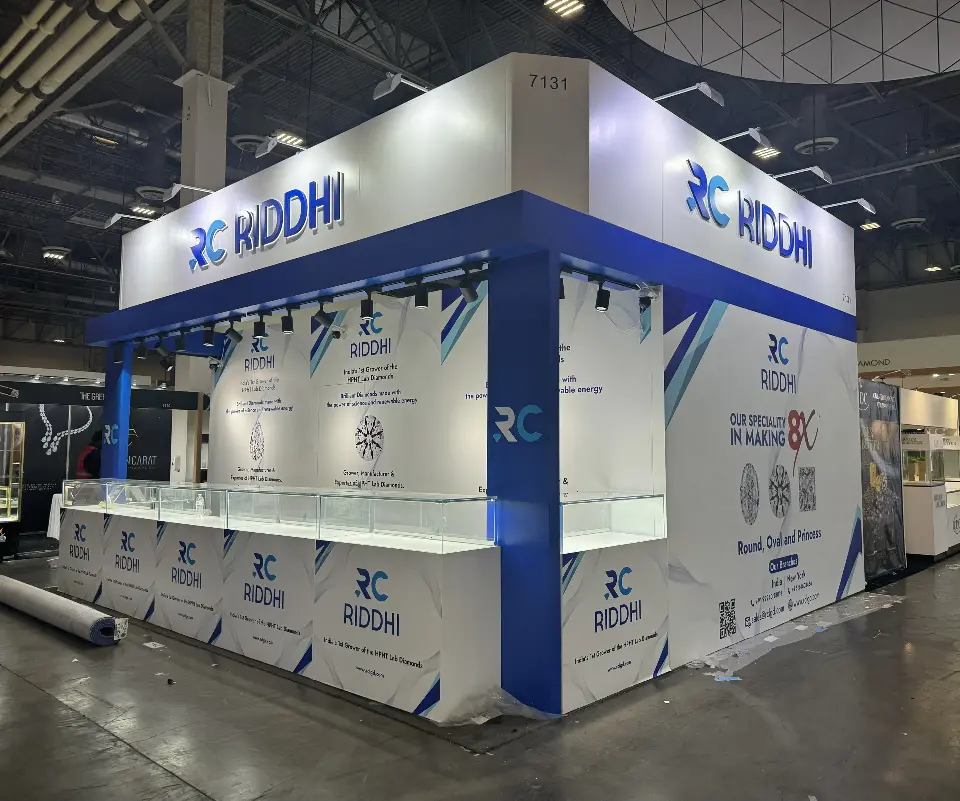 During build-up: RC Riddhi booth with blue frame, logo header and glass display counters