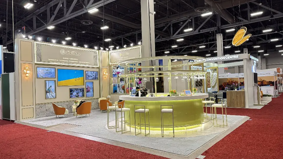 Wide view of the round green bar under a gold ring canopy with lounge seating behind