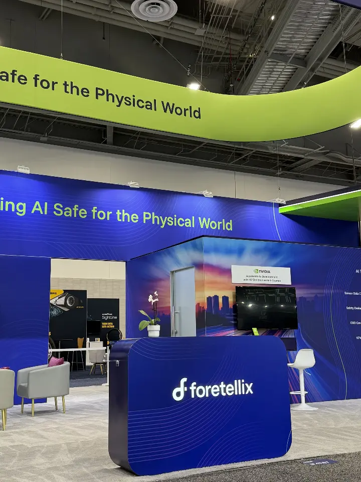 Close view of the branded counter with demo screens on the walls behind