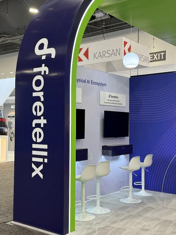 Close view of the arched logo column in front of white demo counters