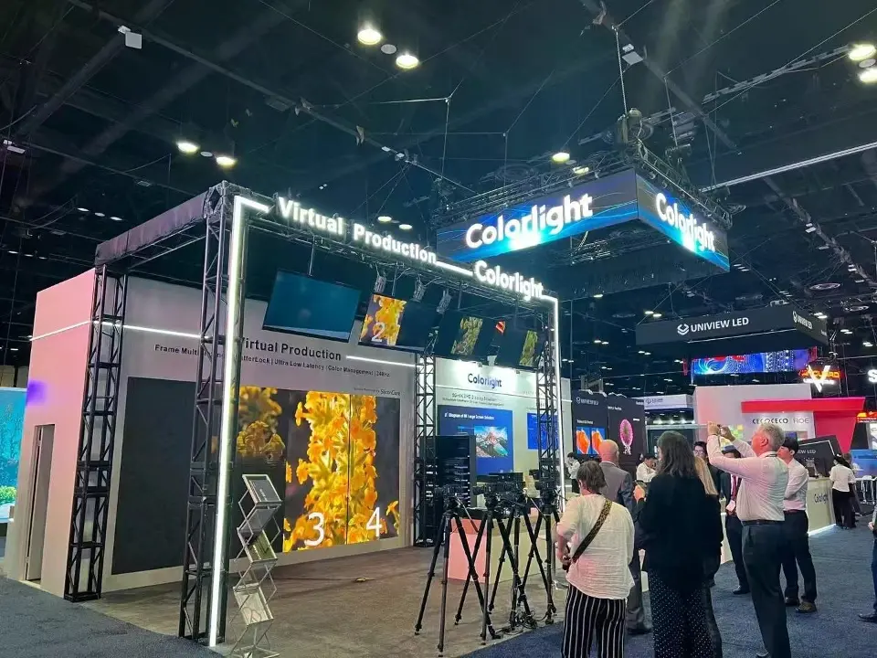 Colorlight Virtual Production truss arch with lit outline, demo screens and camera tripods beneath the hanging Colorlight sign
