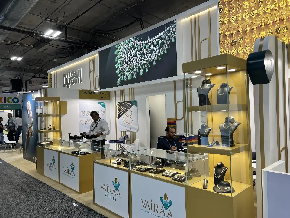 Vairaa Mountings unit with glass counters, necklace busts in a lit tower and emerald necklace graphic