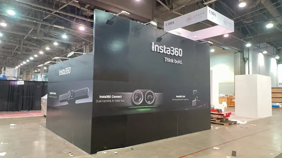 Finished black cube wall with white Insta360 lettering and camera product graphics