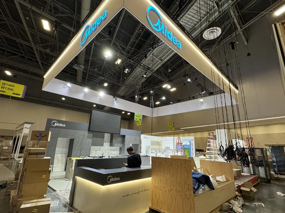 During installation: black counter with a lit base and a worker on a ladder
