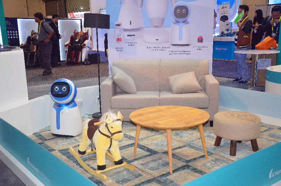 Close view of the living-room set with sofa, wooden table, rocking horse and a companion robot