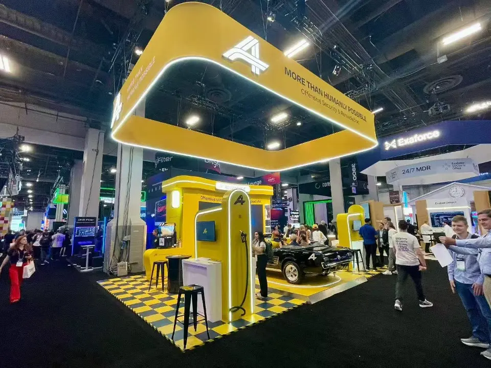 Wide angle of the yellow canopy and checkered floor with visitors around the convertible