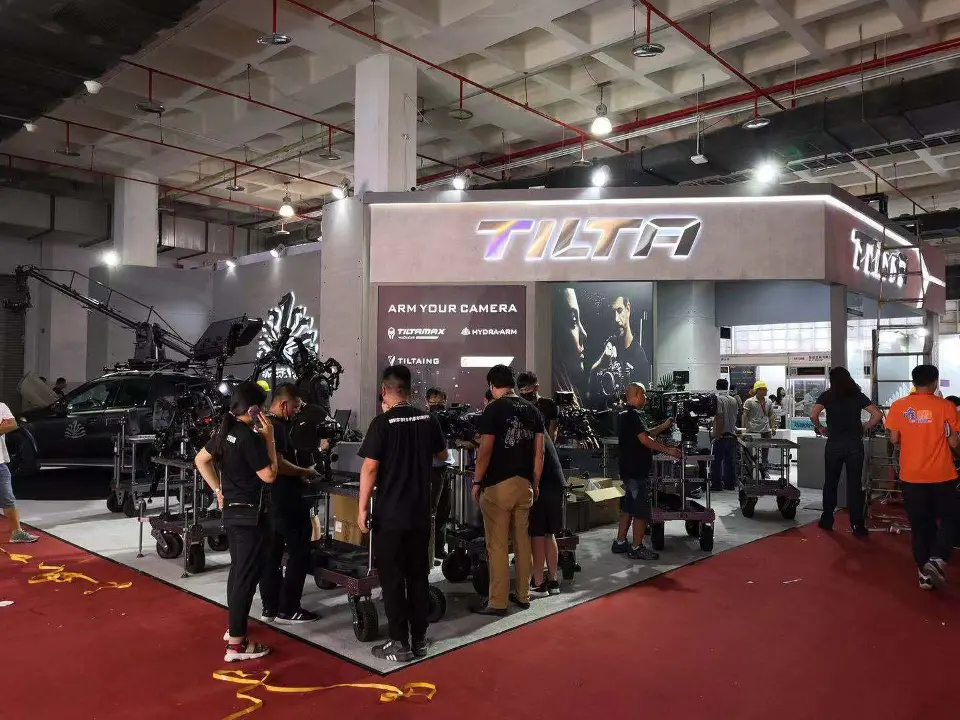 Grey Tilta booth with angled fascia and camera rigs on carts at the front