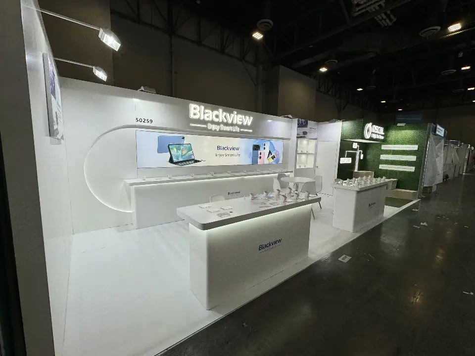Blackview booth side view with lit header, backlit graphic and white counters