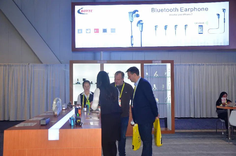 Visitors at the earphone lightbox end of the display counter