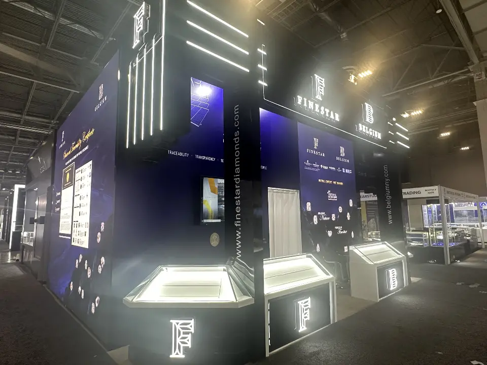 Side view of the black and navy booth with lit showcases along the front