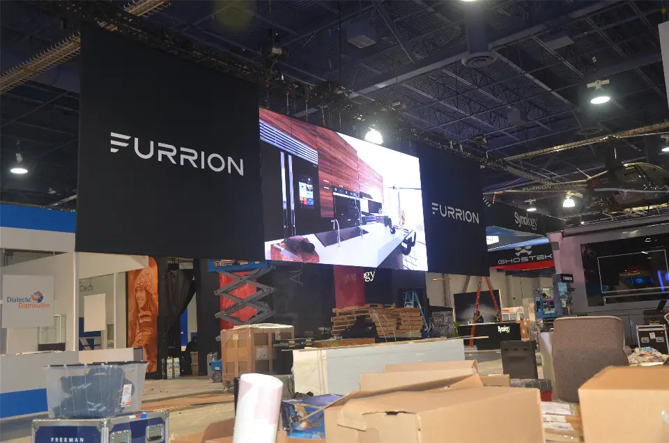 During installation: large hanging video screen with the Furrion logo above boxed products