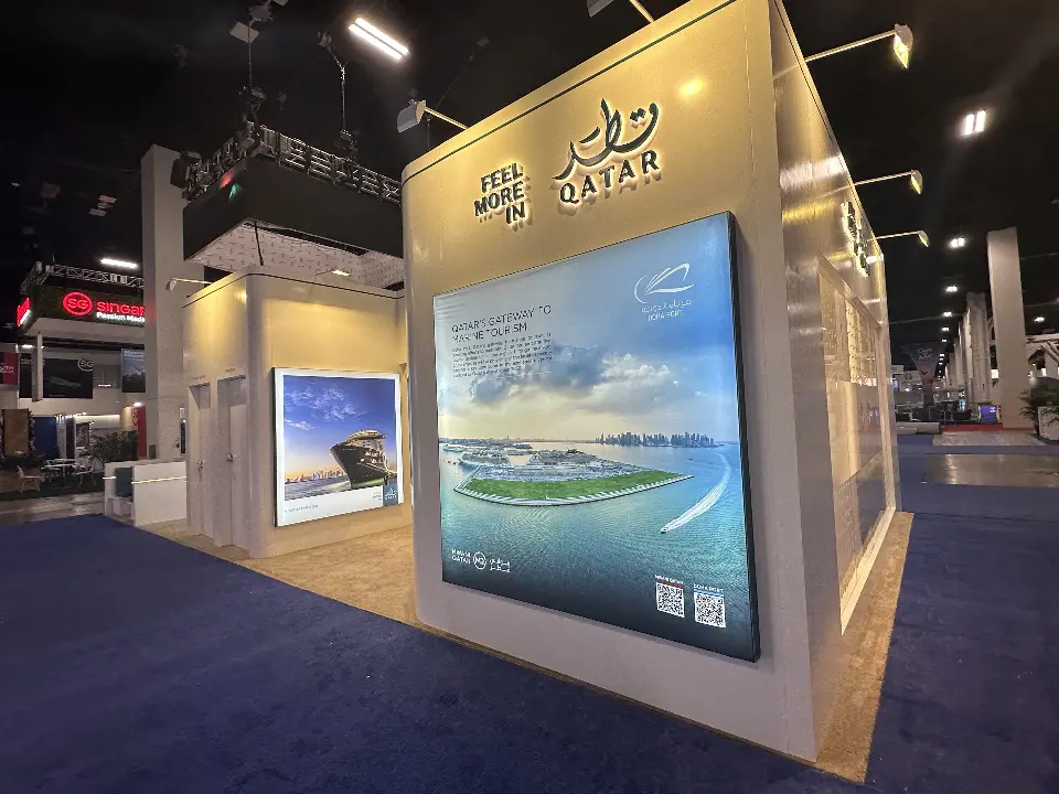 White Feel More in Qatar tower with Qatar logo lettering and a large illuminated waterfront graphic