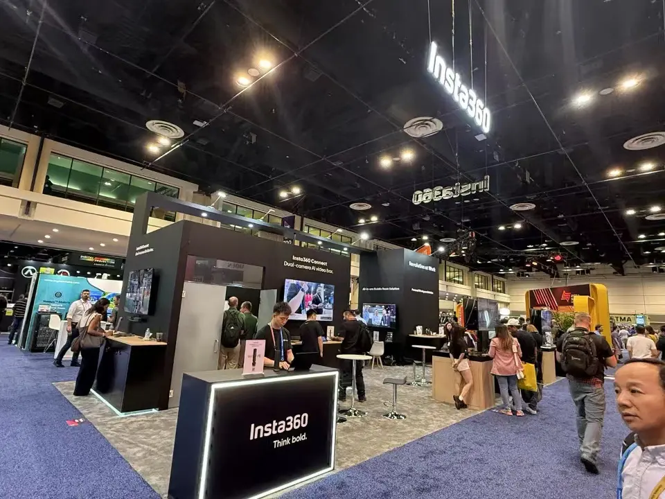 Angled view of black display walls and a lit Insta360 counter in the aisle
