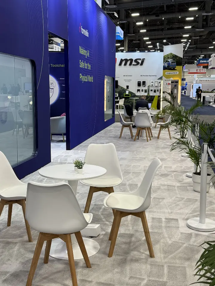 Cafe seating with a potted palm along the outer booth wall
