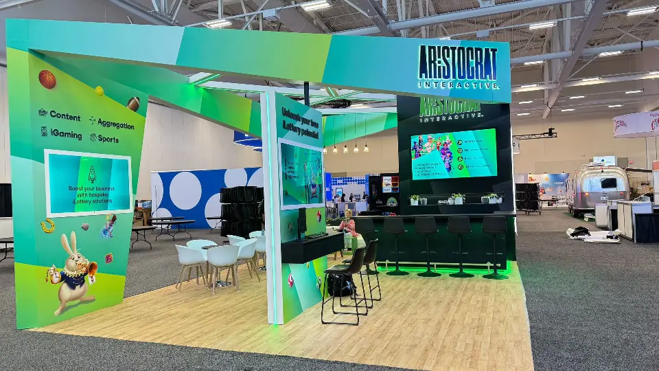 Rear bar area with green under-glow, Aristocrat Interactive sign and screen showing a map