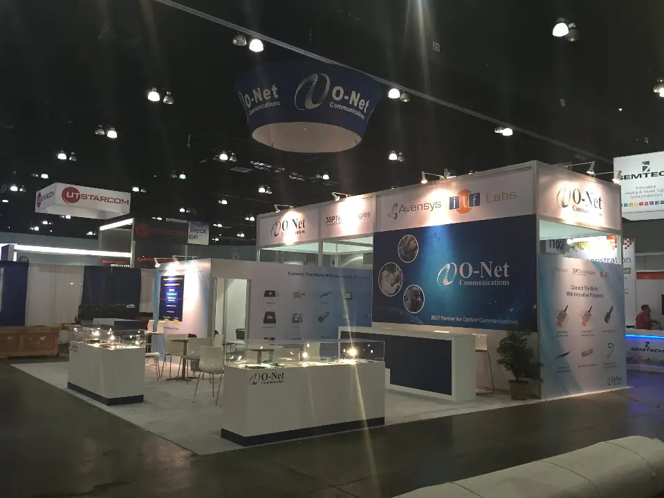 Aisle view of the O-Net booth under its hanging ring sign at the show
