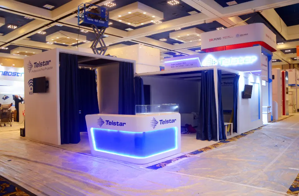 Blue-lit counter in front of curtained rooms with a lift above