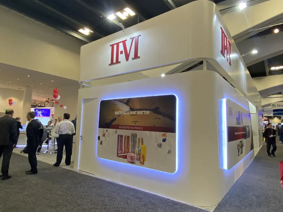 Booth corner with a backlit framed graphic and lit edge on the white wall