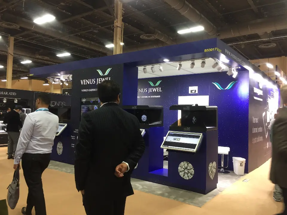 Visitors gathered at the display cases and touchscreens of the booth