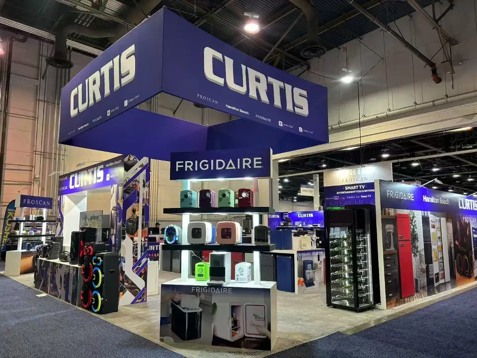 Curtis booth corner with navy hanging sign above shelves of small appliances