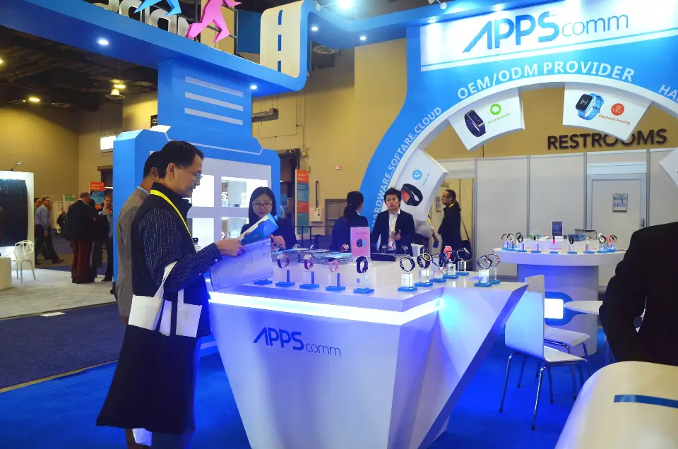 Lit white counter with smartwatches on display and staff behind