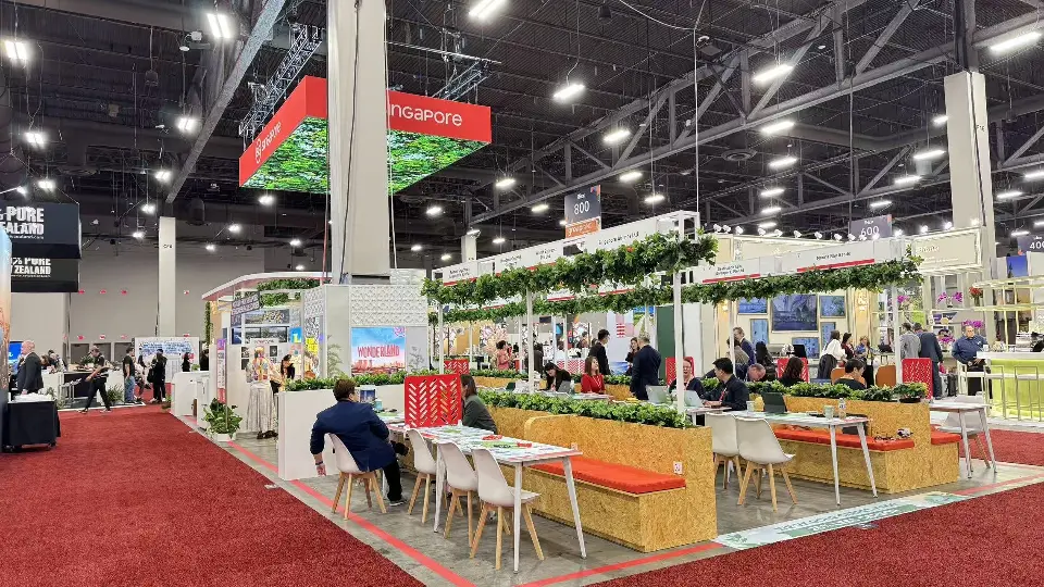 Pavilion meeting area with wood-look counters, orange benches and vine pergolas