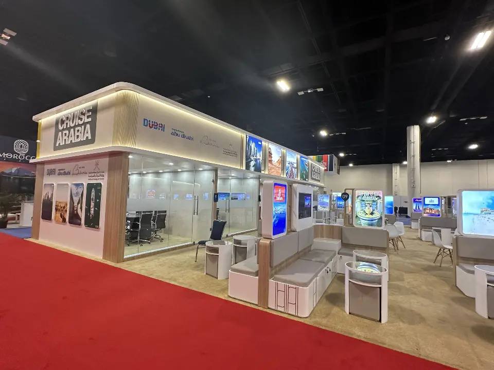 Side view of meeting pods and backlit panels along the booth edge